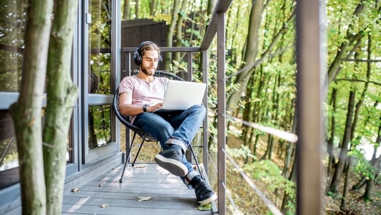 man on deck with laptop, how to make money on the road