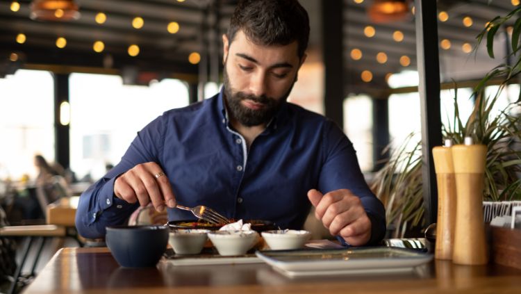 man eating alone in restaurant