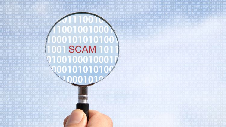 image of magnifying glass revealing the word scam