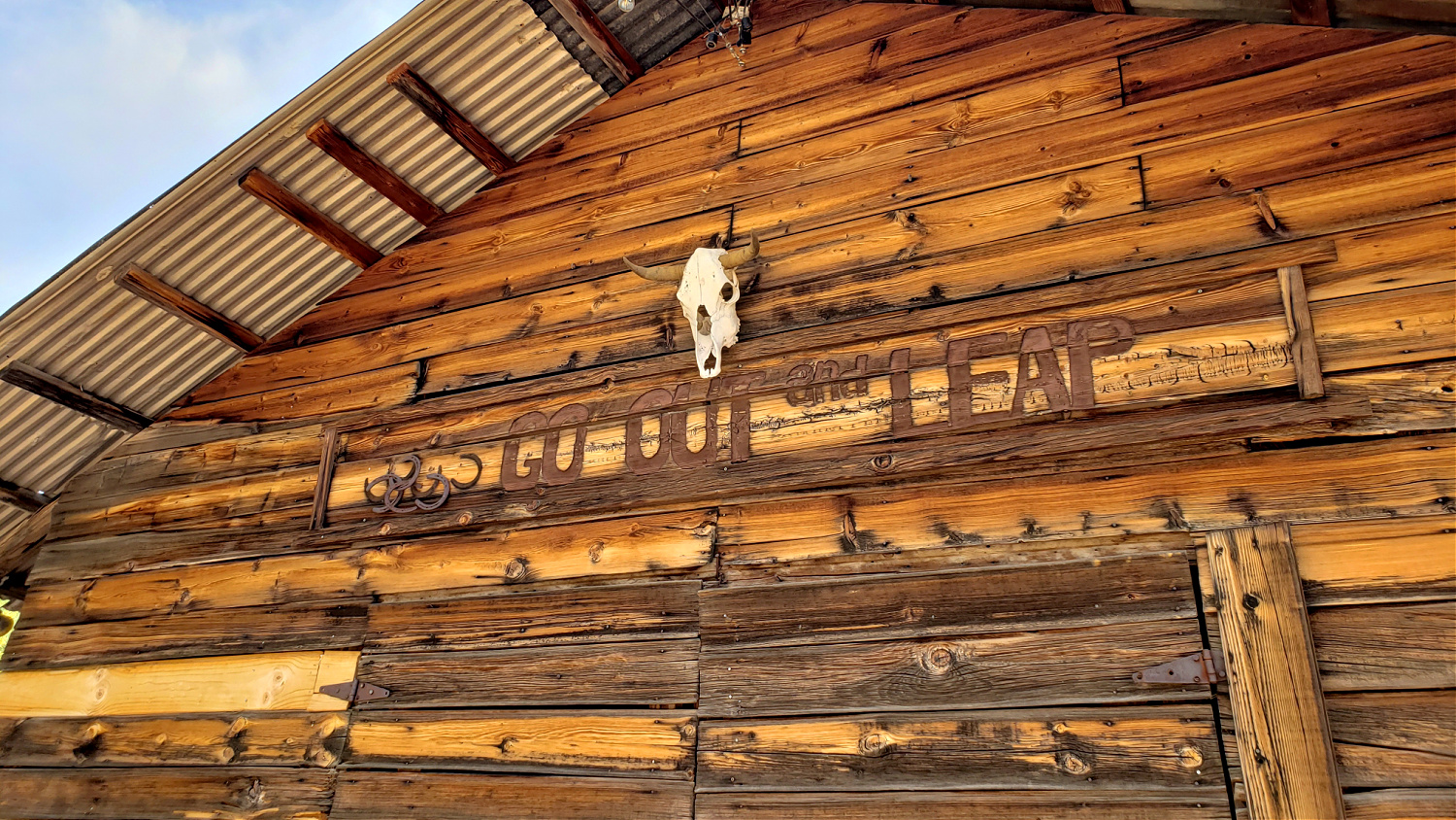 Go OUt and Leap carved into the side of a building at Saguaro Lake Guest Ranch