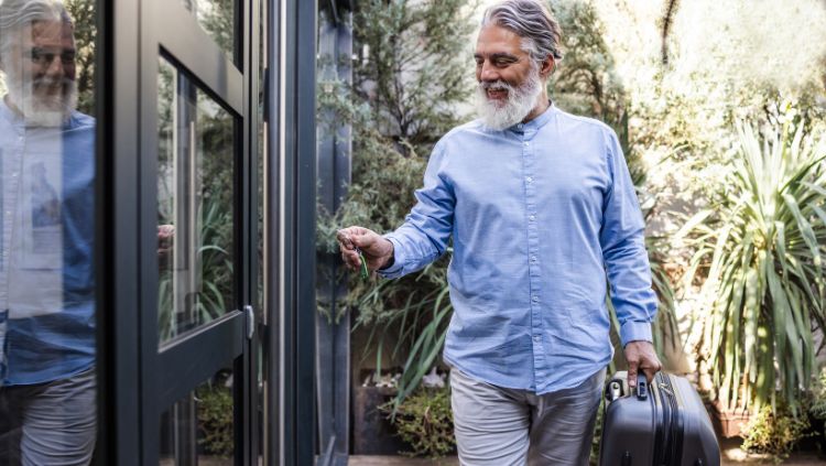 senior man walking with suitcase