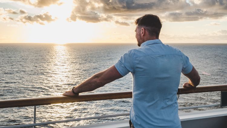 man standing alone on cruise ship