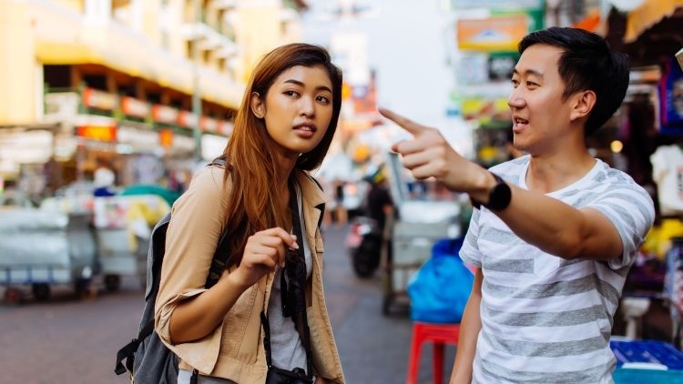 Strangers helping strangers by giving directions.