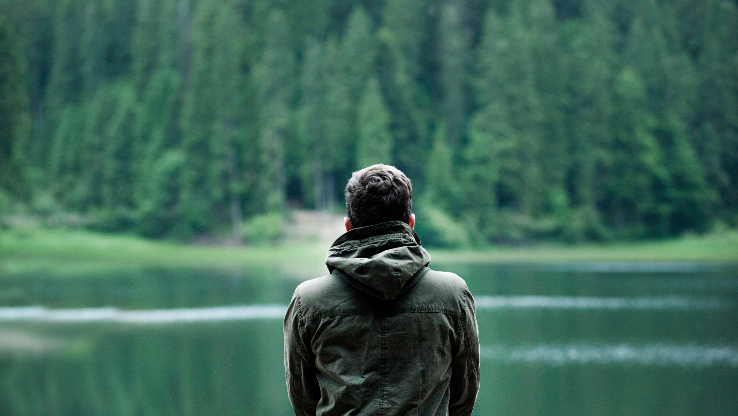 solo travel teaches you the value of solitude as this traveler gazes out over lake